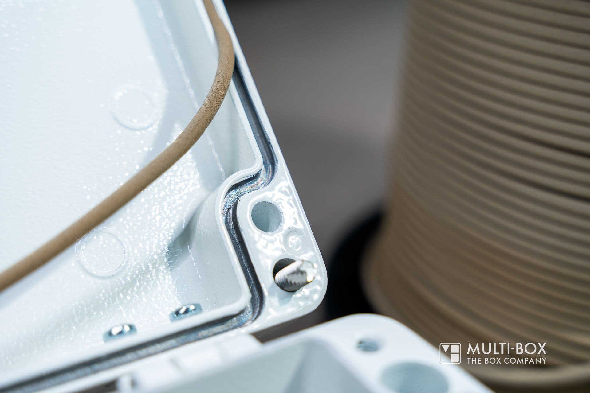 A close-up of an enclosure with a gasket and screws, ideal for EMC protection in industrial applications.